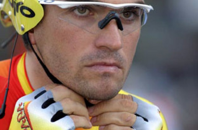 A concentrating Gonzalez de Galdeano adjusts his helmet strap. Photo copyright Paul Sampara Photography.