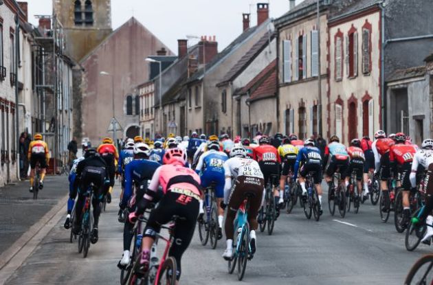 Cyclists cornering in French village during stage 2 of Paris-Nice 2023