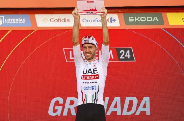 Adam Yates celebrates his stage victory on the podium