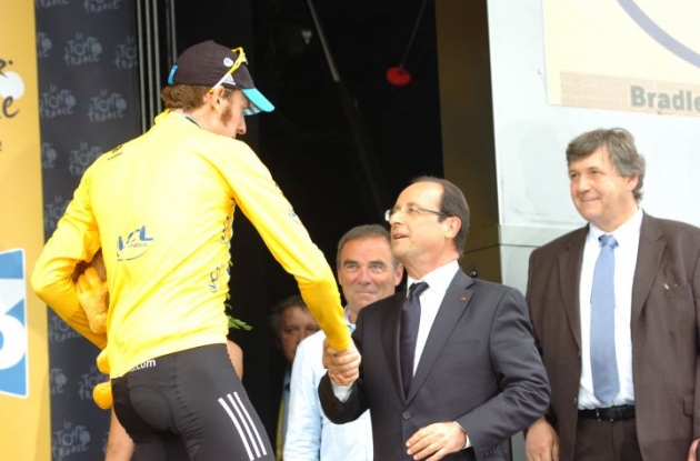 Team Sky Procycling's Bradley Wiggins greets Francois Hollande. Wiggins leads the 2012 Tour de France ahead of teammate Christopher Froome and Team Liquigas-Cannondale's 
Vincenzo Nibali. Photo Fotoreporter Sirotti.