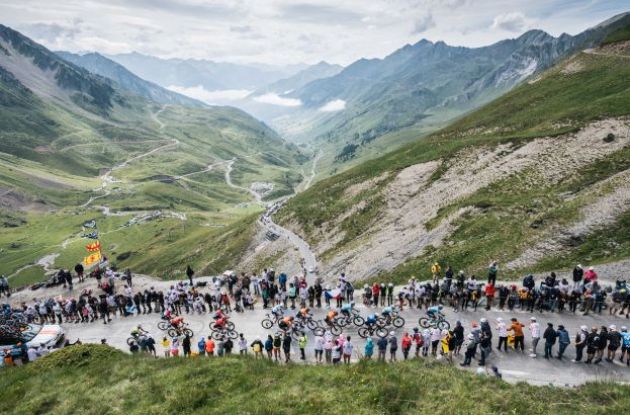 Cyclists climbing with view over Col du Tourmalet mountains