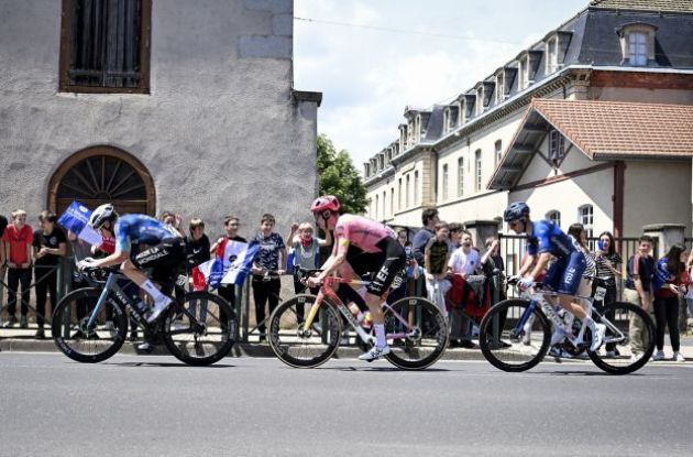 Cyclists riding through French village