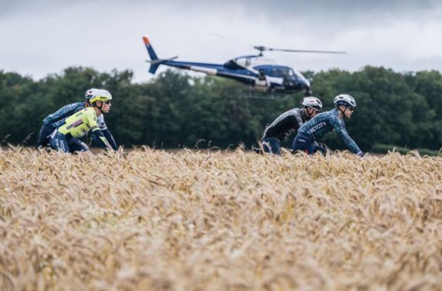 Cyclists followed by helicopter