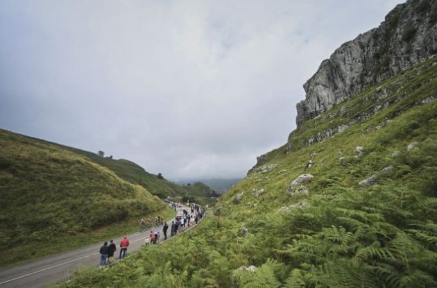 Vuelta cyclists riding through Spanish mountain landscape