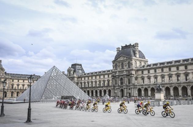 The Tour de France cyclists riding past the Louvre museum in Paris France