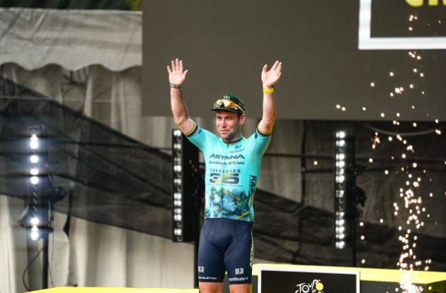 Mark Cavendish on the podium with fireworks