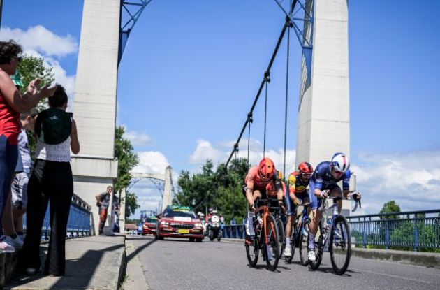 Tour de France cyclists crossing bridge