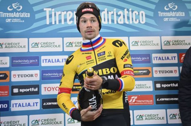Primoz Roglic celebrates his stage victory opening a bottle of Asti 