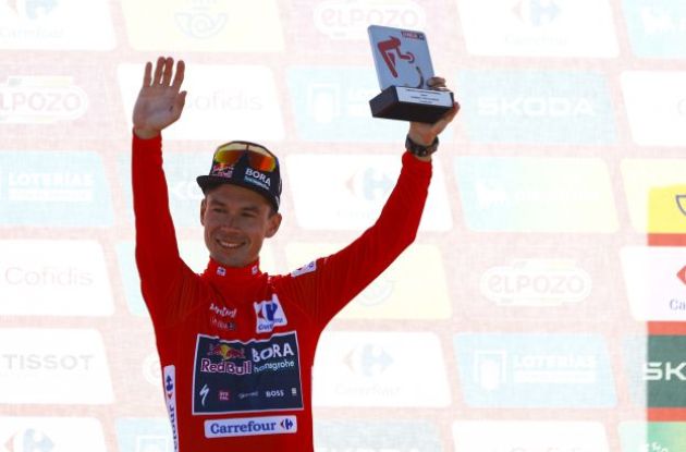 Primoz Roglic on the podium in the red jersey at La Vuelta