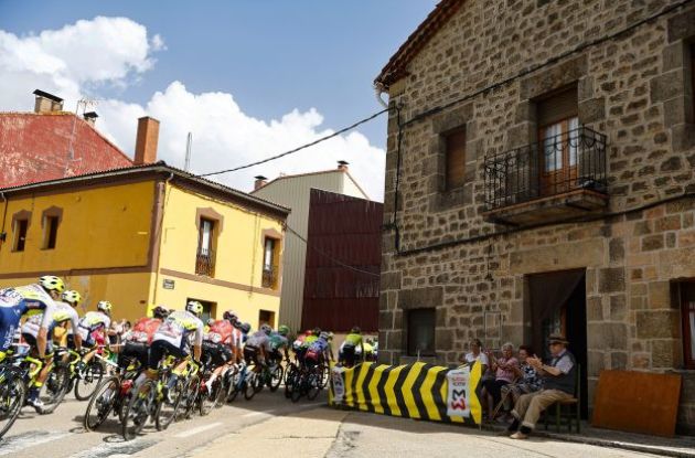 Cyclists passing through spanish village during stage 11 of Vuelta a Espana