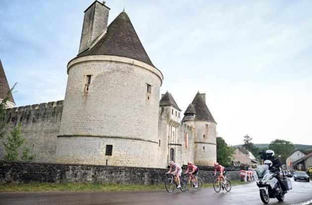 Stefan Bissegger Neilson Powless and Jonas Abrahamsen ride past a French castle