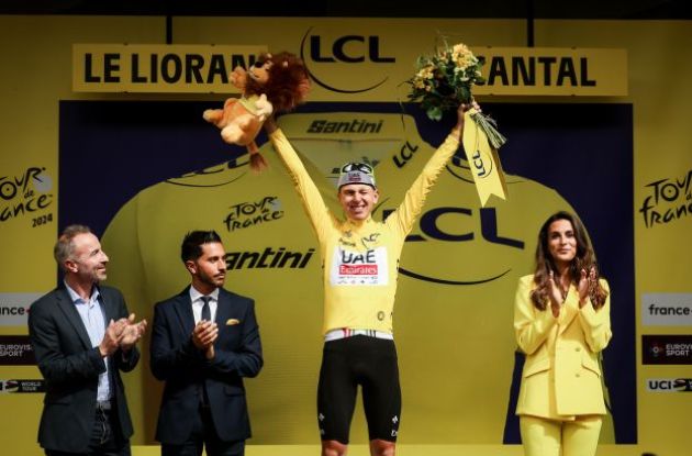 Tadej Pogacar wearing yellow on the Tour de France podium