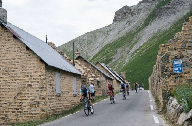 Tour de France cyclists passing though dead mountain village