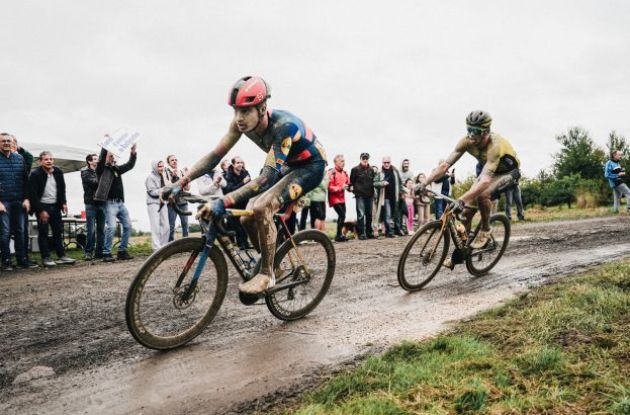 Matias Vacek and Christophe Laporte riding through mud