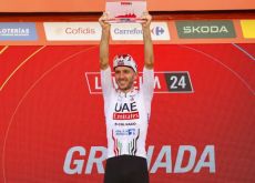 Adam Yates celebrates his stage victory on the podium