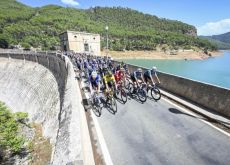 La Vuelta peloton crossing dam