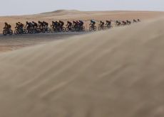 pro cyclists riding through desert