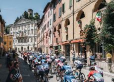 Tour de France riders climbing though Italian village