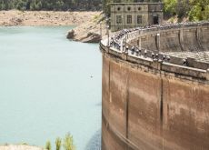 La Vuelta cyclists passing historic dam