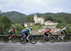 Cyclists in breakaway pass by French castle