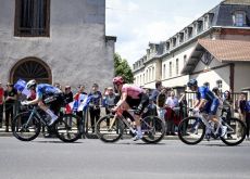 Cyclists riding through French village