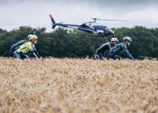 Cyclists followed by helicopter