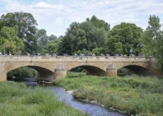 Cyclists on historic bridge in Rioja