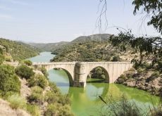 Cyclists crossing historic bridge