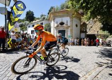 Euskaltel cyclist passes by Portuguese church