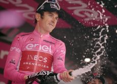 Geraint Thomas celebrates with champagne on the Giro d'Italia podium