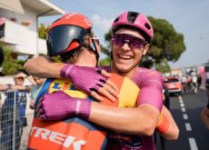 Jonathan Milan smilingly hugs teammate from Lidl-Trek