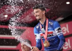 Julian Alaphilippe celebrates his stage victory with champagne on the Giro d'Italia podium