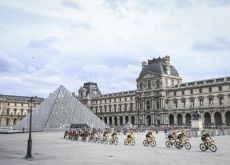 The Tour de France cyclists riding past the Louvre museum in Paris France