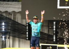 Mark Cavendish on the podium with fireworks