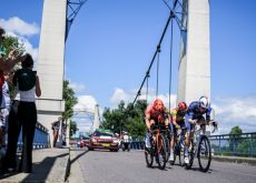 Tour de France cyclists crossing bridge