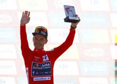 Primoz Roglic on the podium in the red jersey at La Vuelta