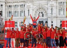 Primoz Roglic with red Specialized S-Works bike and team staff