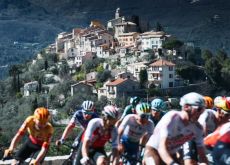 Cyclists pass mountain village near Nice in France