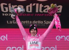 Tadej Pogacar celebrates his Giro d'Italia lead in the pink jersey on the podium