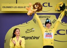 Tadej Pogacar wearing the yellow jersey on the Tour de France podium