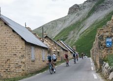 Tour de France cyclists passing though dead mountain village