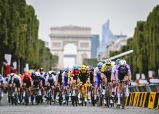 The Tour de France peloton on the Champs Elysees boulevard in Paris