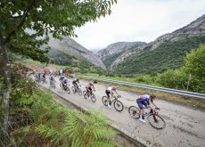 Cyclists riding through Lagos de Covadonga during Vuelta a Espana