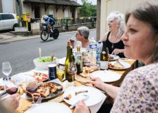 Women having dinner while watching cyclists in Tour de France 2024