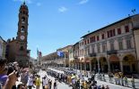 Cyclists riding through streets of Bologna in stage 2 of Tour de France 2024