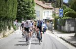 Cyclists riding though French village