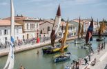 Tour de France peloton passing by historic boats in stage 2