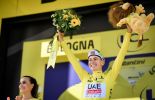 Tadej Pogacar in the yellow jersey on the Tour de France podium
