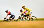 Tadej Pogacar riding on his yellow Colnago bike