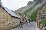 Tour de France cyclists passing though dead mountain village